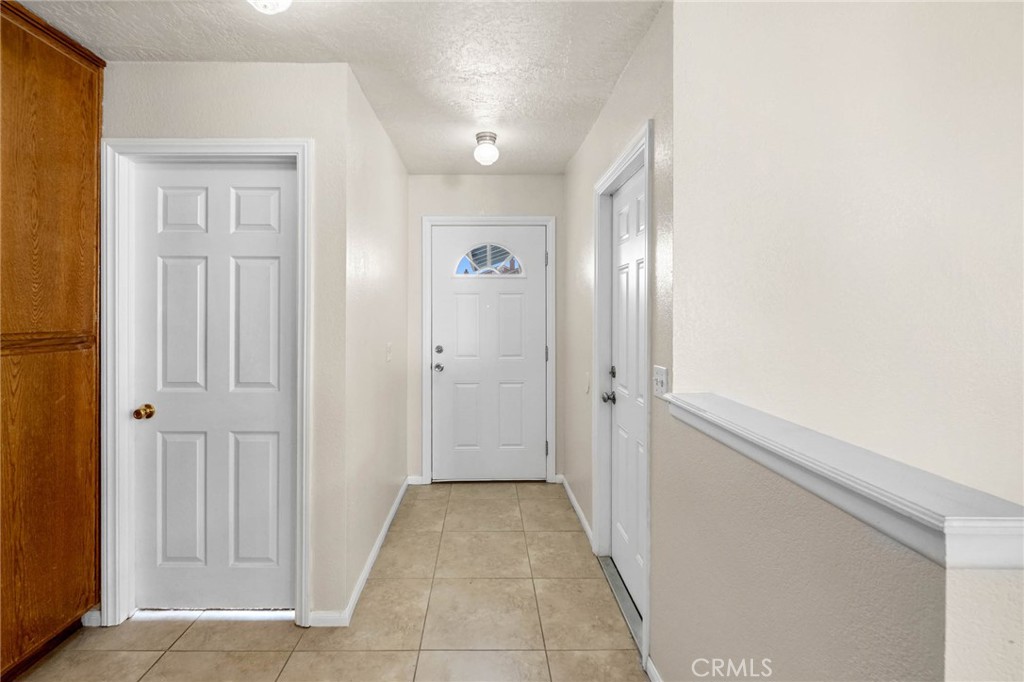 13904 Hidden Valley Road Victorville, CA 92395 - Photo 4 of 47 a view of a hallway with closet and bathroom