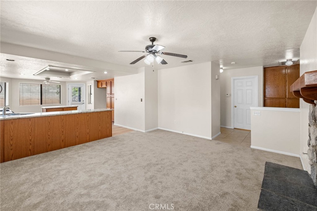 13904 Hidden Valley Road Victorville, CA 92395 - Photo 7 of 47 a view of a kitchen with a sink and a refrigerator