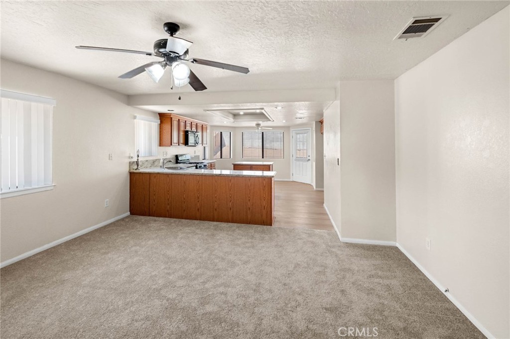 13904 Hidden Valley Road Victorville, CA 92395 - Photo 9 of 47 a view of a kitchen with a sink and cabinet area