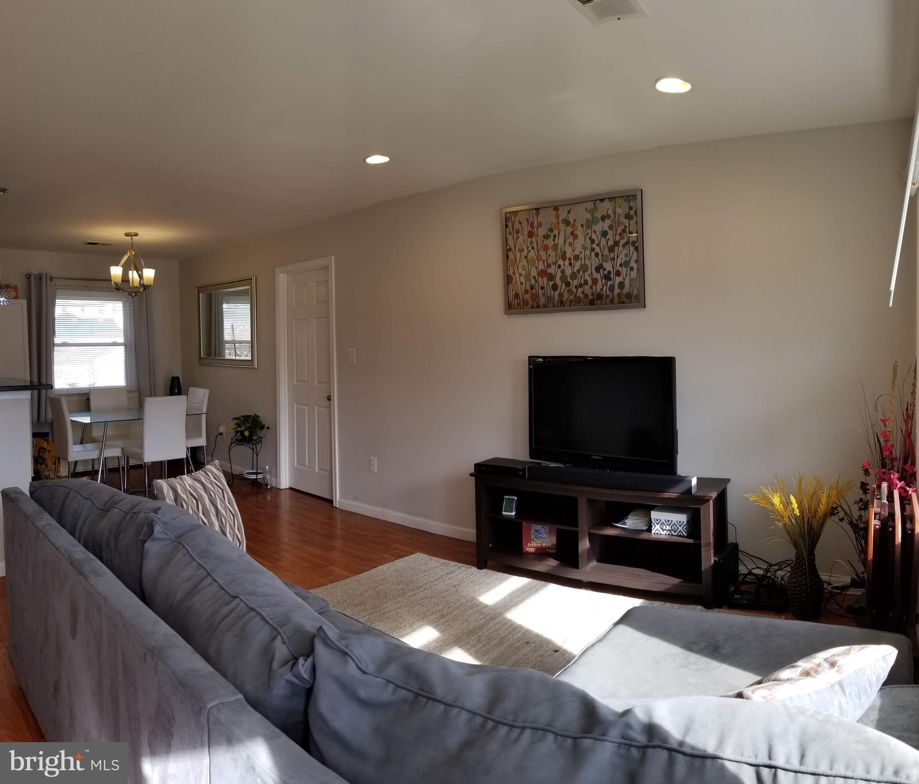 303 East Poplar Road Sterling, VA 20164 - Photo 3 of 12 LIVING ROOM TOWARDS EATING SPACE