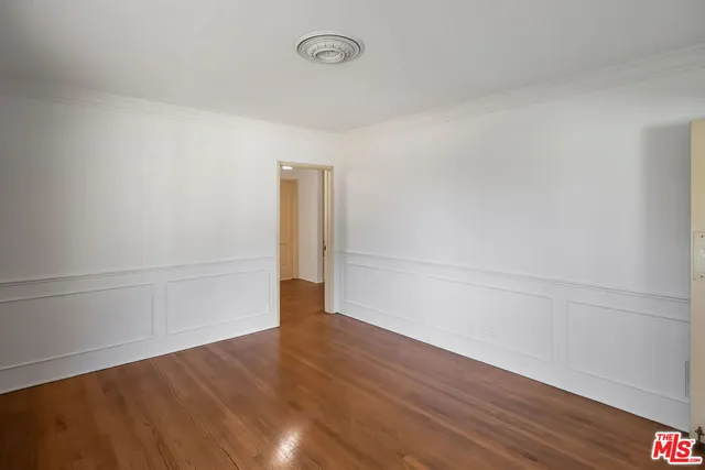 a view of an empty room and wooden floor