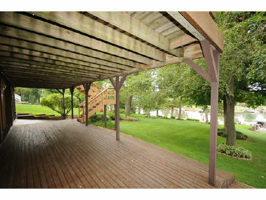 7 Lake Summerset Road Lake Summerset, IL 61019 - Photo 8 of 11 a backyard of a house with a garden and outdoor seating