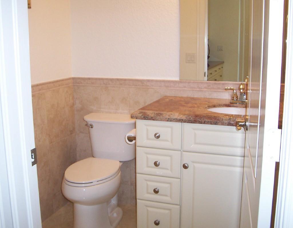 1059 E Road Loxahatchee, FL 33470 - Photo 29 of 82 a bathroom with a granite countertop toilet and a sink