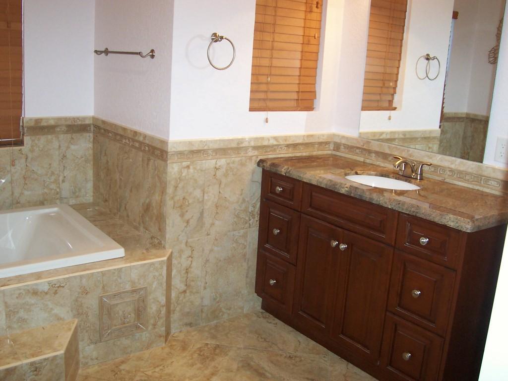 1059 E Road Loxahatchee, FL 33470 - Photo 35 of 82 a bathroom with a granite countertop sink and a bathtub