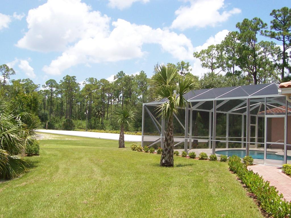 1059 E Road Loxahatchee, FL 33470 - Photo 38 of 82 a view of a swimming pool with an outdoor space and seating area