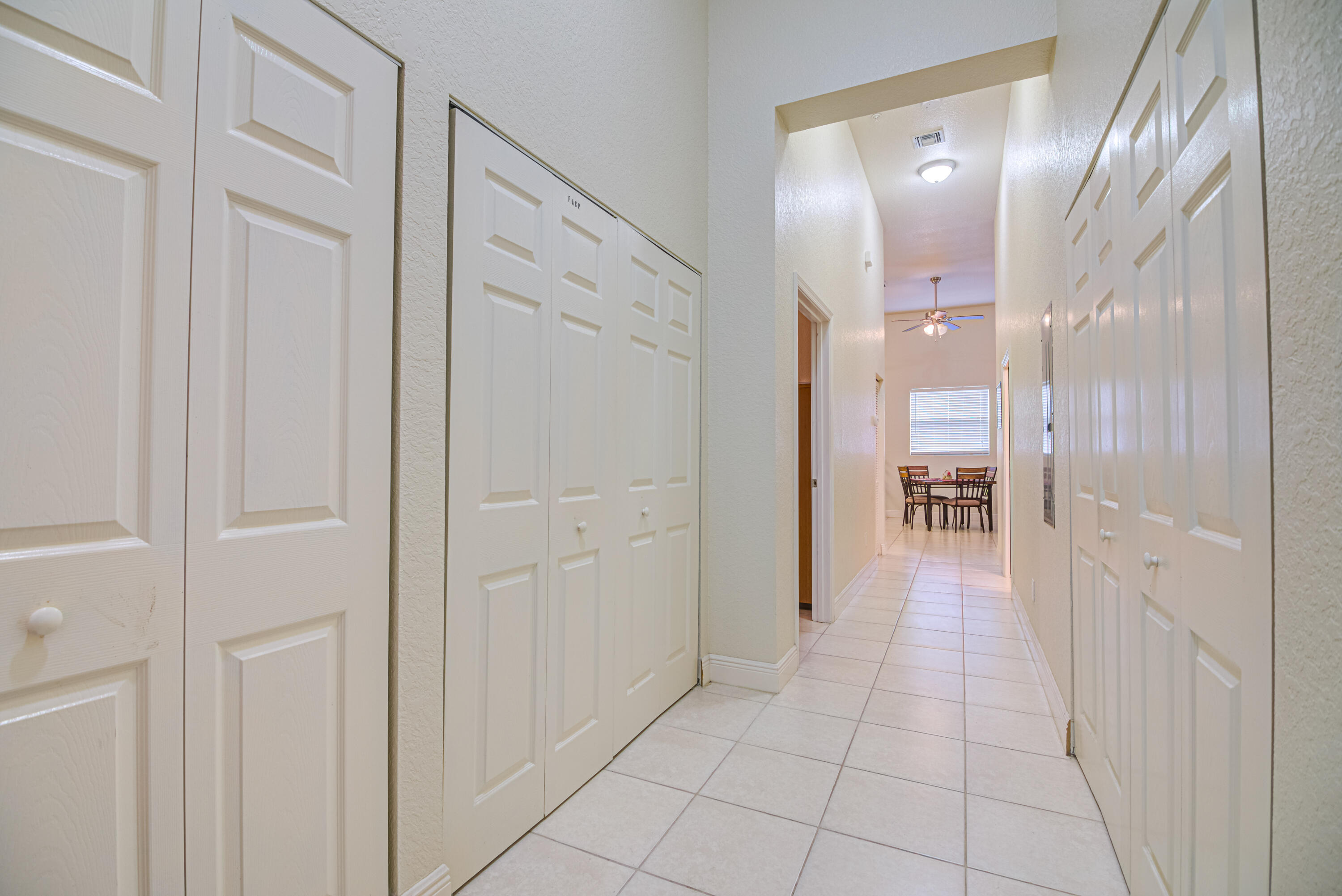 1059 E Road Loxahatchee, FL 33470 - Photo 56 of 82 a hallway with sliding door and view of bathroom