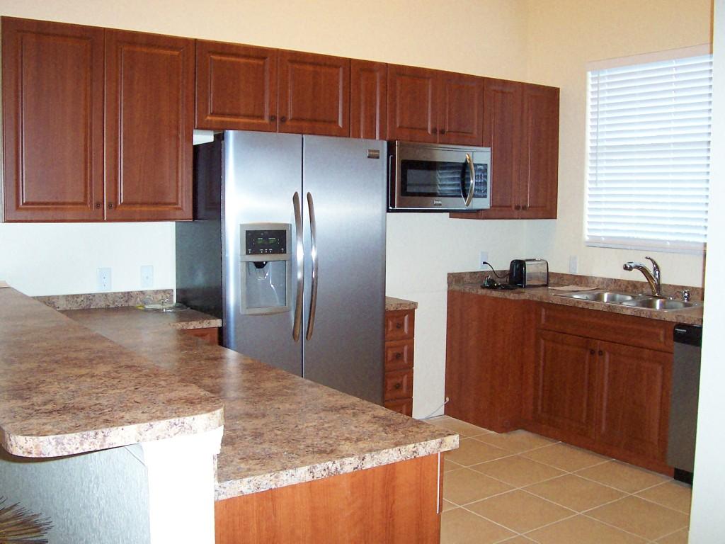 1059 E Road Loxahatchee, FL 33470 - Photo 60 of 82 a kitchen with stainless steel appliances granite countertop a refrigerator and a sink