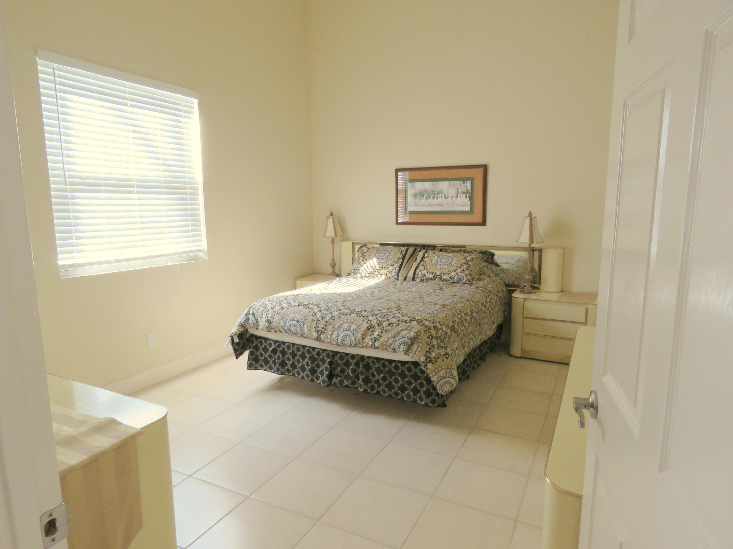 1059 E Road Loxahatchee, FL 33470 - Photo 63 of 82 a bedroom with a bed and a window