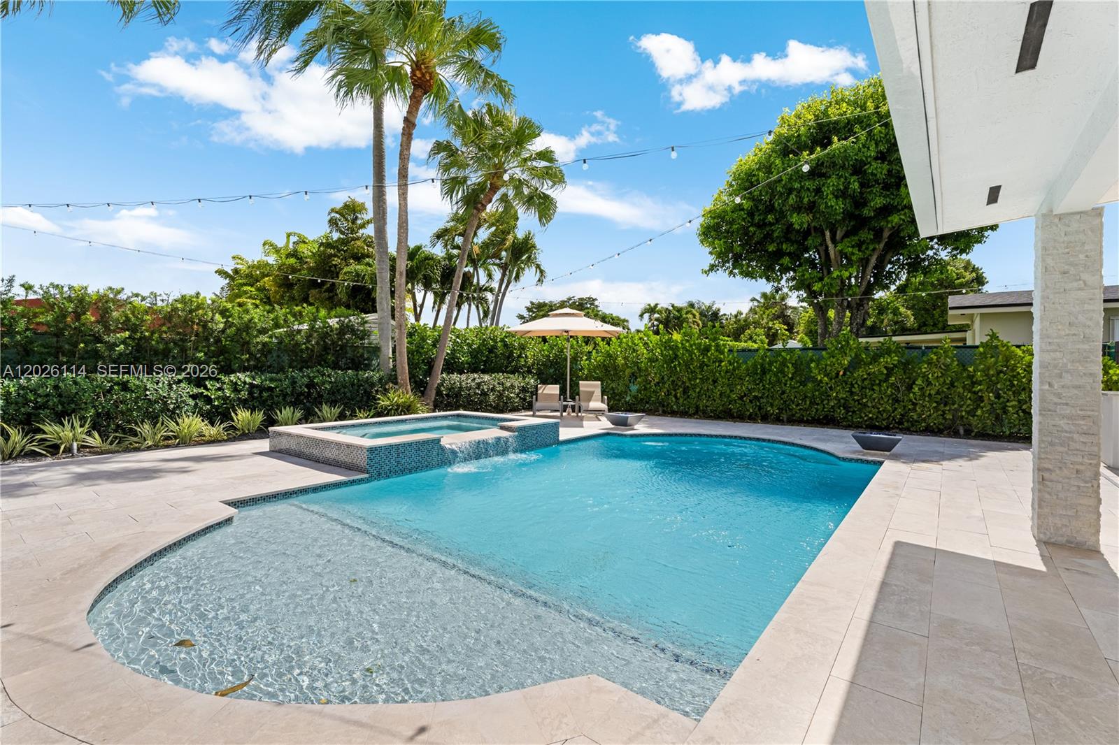 9641 Southwest 66th Street Miami, FL 33173 - Photo 40 of 57 a view of a swimming pool with a yard and palm trees