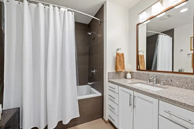 a bathroom with a double vanity sink and mirror