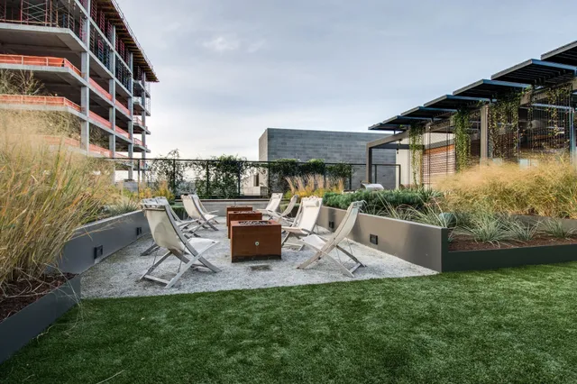 a view of a house with backyard porch and sitting area