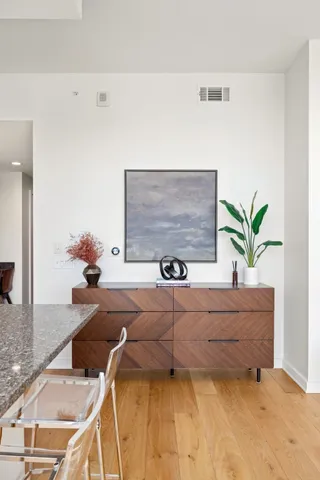 a living room with furniture flowerpot and wooden floor