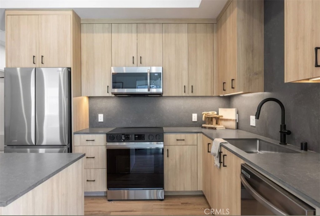 8500 Haven Avenue Rancho Cucamonga, CA 91730 - Photo 2 of 4 a kitchen with stainless steel appliances granite countertop a stove a sink and a refrigerator