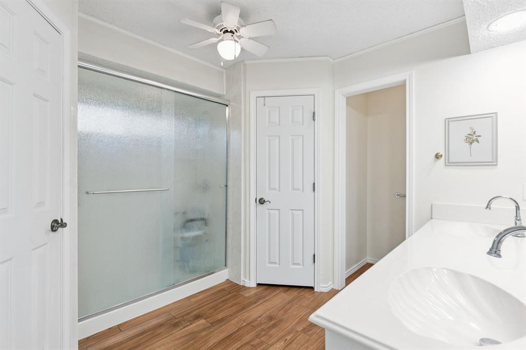 231 Rancho Vista Drive Double Oak, TX 75077 - Photo 16 of 26 a bathroom with a bathtub and a shower