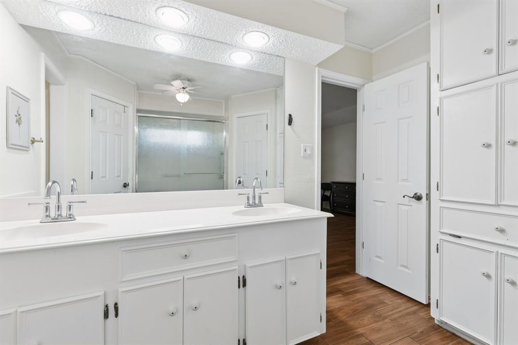 231 Rancho Vista Drive Double Oak, TX 75077 - Photo 17 of 26 a bathroom with a sink double vanity and a mirror