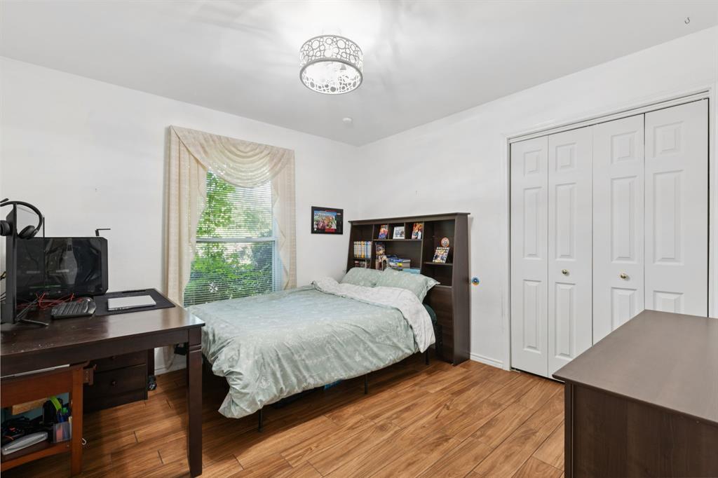 231 Rancho Vista Drive Double Oak, TX 75077 - Photo 18 of 26 a bedroom with a bed and a window