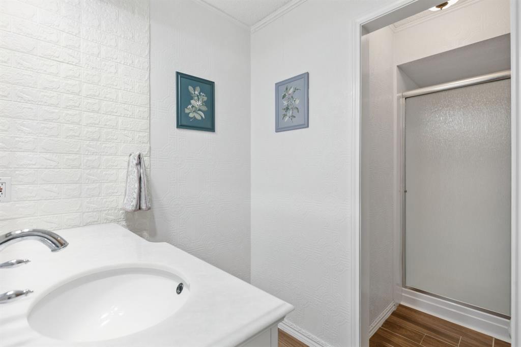 231 Rancho Vista Drive Double Oak, TX 75077 - Photo 19 of 26 a bathroom with a white cabinet and a sink