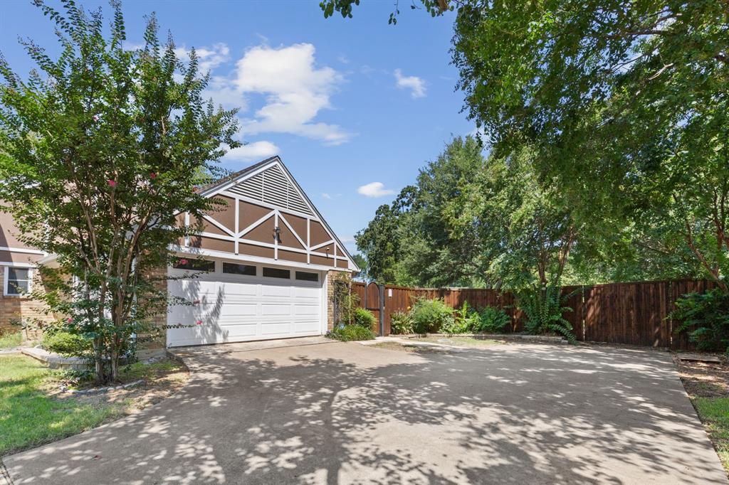 231 Rancho Vista Drive Double Oak, TX 75077 - Photo 24 of 26 a front view of a house with a yard and garage