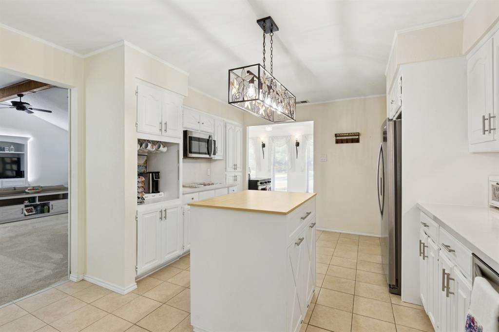 231 Rancho Vista Drive Double Oak, TX 75077 - Photo 10 of 26 a view of a kitchen with a sink dishwasher stove and white cabinets