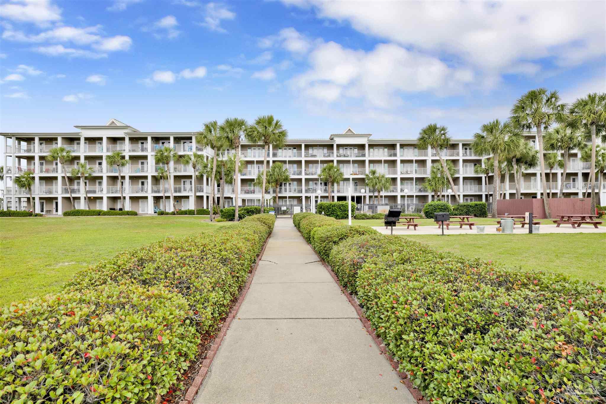 13351 Johnson Beach Road, Unit 203E Perdido Key, FL 32507 - Photo 44 of 55 a view of a swimming pool and a chairs