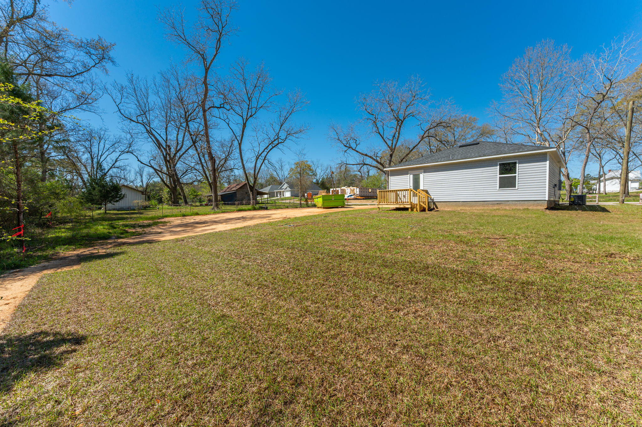8095 3rd Street Laurel Hill, FL 32567 - Photo 28 of 30 a view of a large house with a yard and a large tree