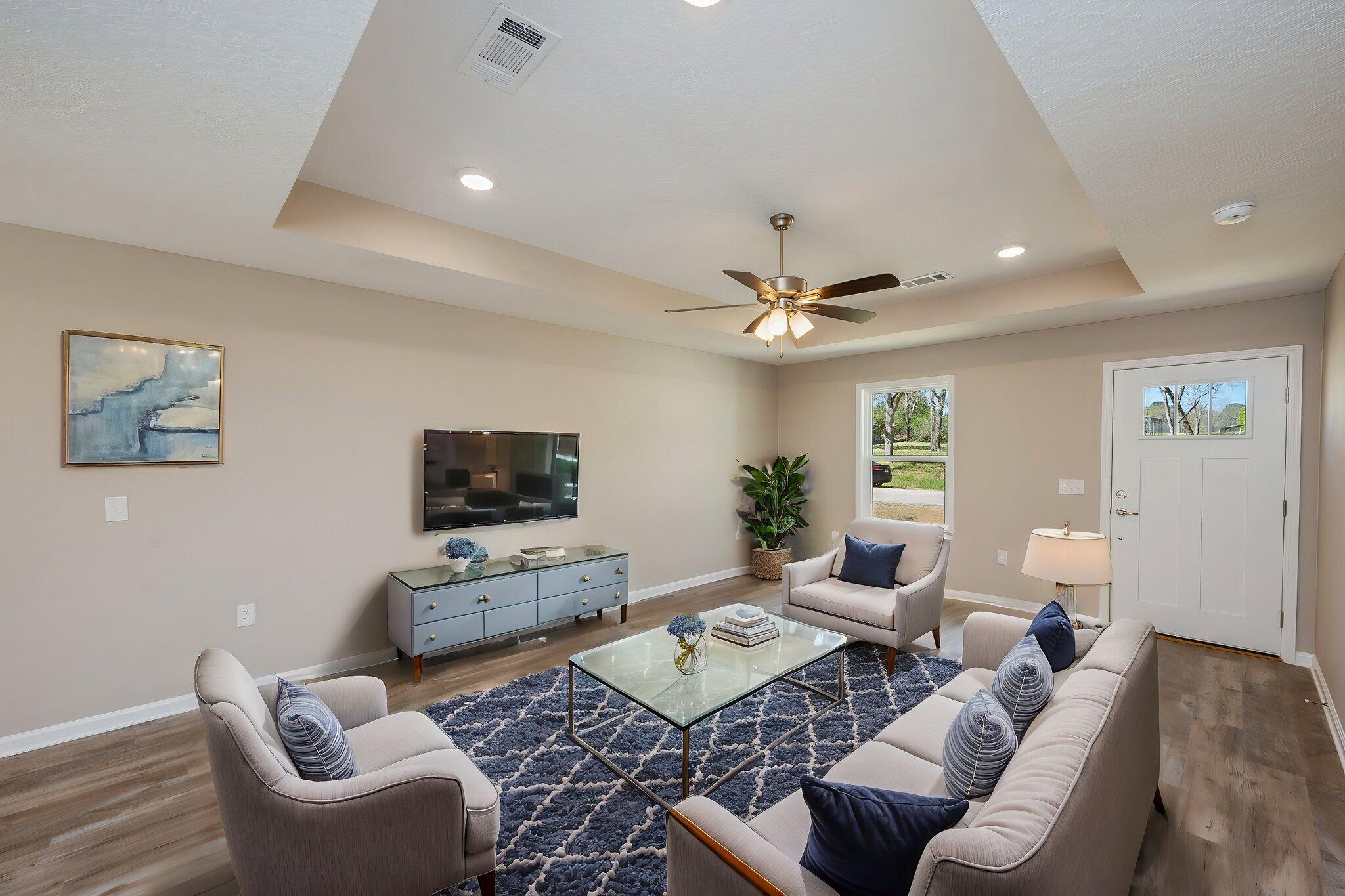 8095 3rd Street Laurel Hill, FL 32567 - Photo 10 of 30 a living room with furniture and a flat screen tv