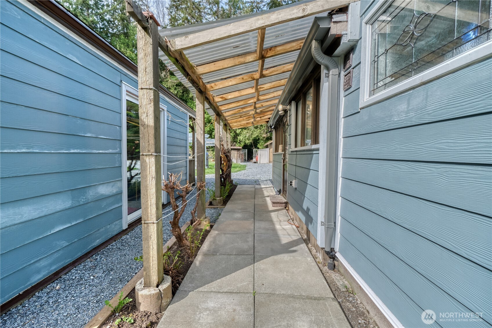 1871 Johnson Road Point Roberts, WA 98281 - Photo 19 of 36 a view of a pathway of a house with wooden walls and stairs