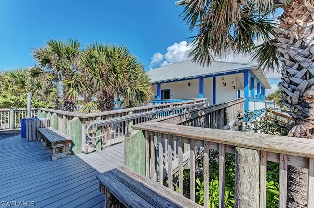 a view of a wooden deck and a backyard