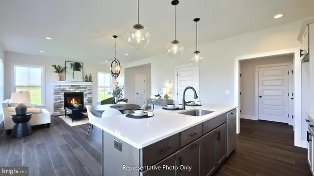 a kitchen with sink and wooden floor