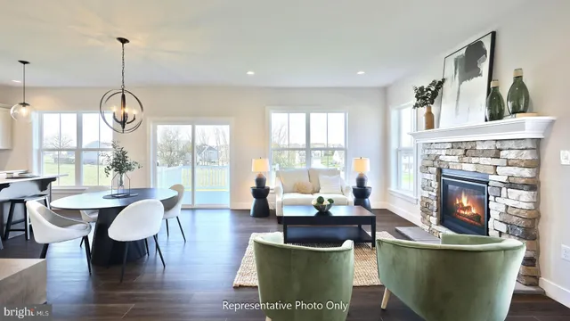 a living room with dining table and a fireplace