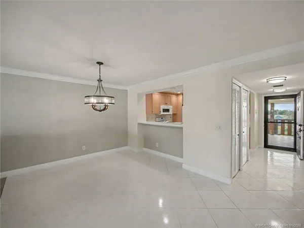 an empty room with windows and entrance