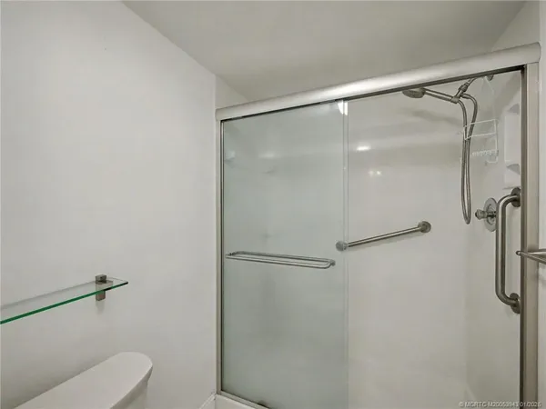 a bathroom with a shower and toilet
