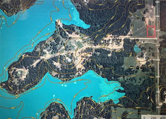 a green field with lots of trees