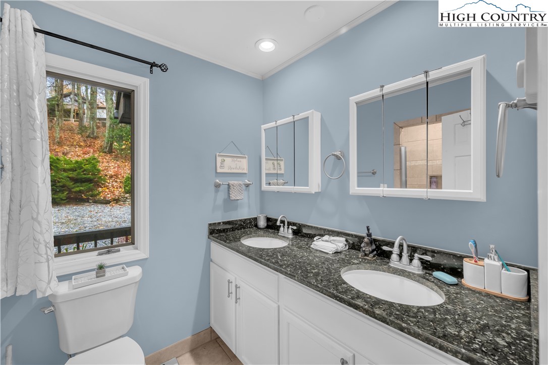 555 Glenview Road Newland, NC 28657 - Photo 18 of 49 a bathroom with a granite countertop sink mirror and a toilet