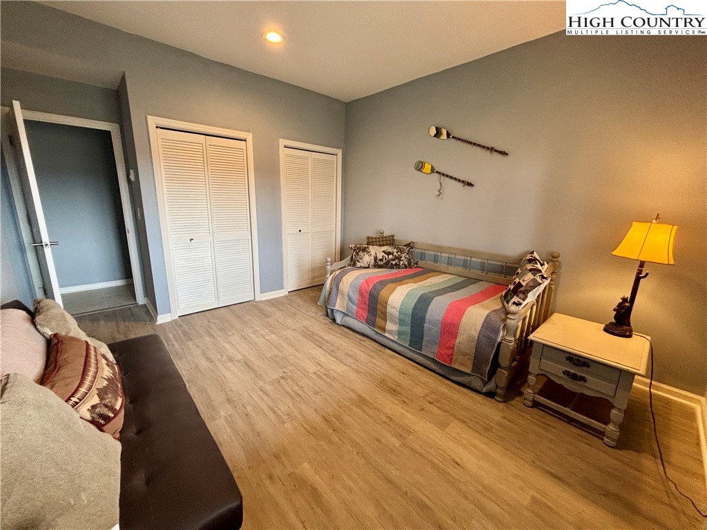 555 Glenview Road Newland, NC 28657 - Photo 34 of 49 a bedroom with a bed and wooden floor