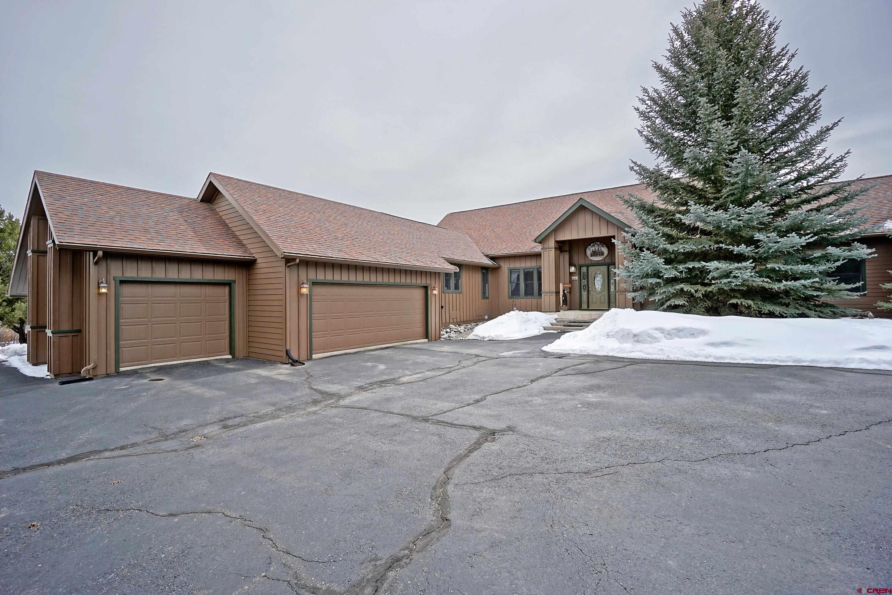 221 Waterview Lane Ridgway, CO 81432 - Photo 1 of 43 a front view of a house with a yard and garage