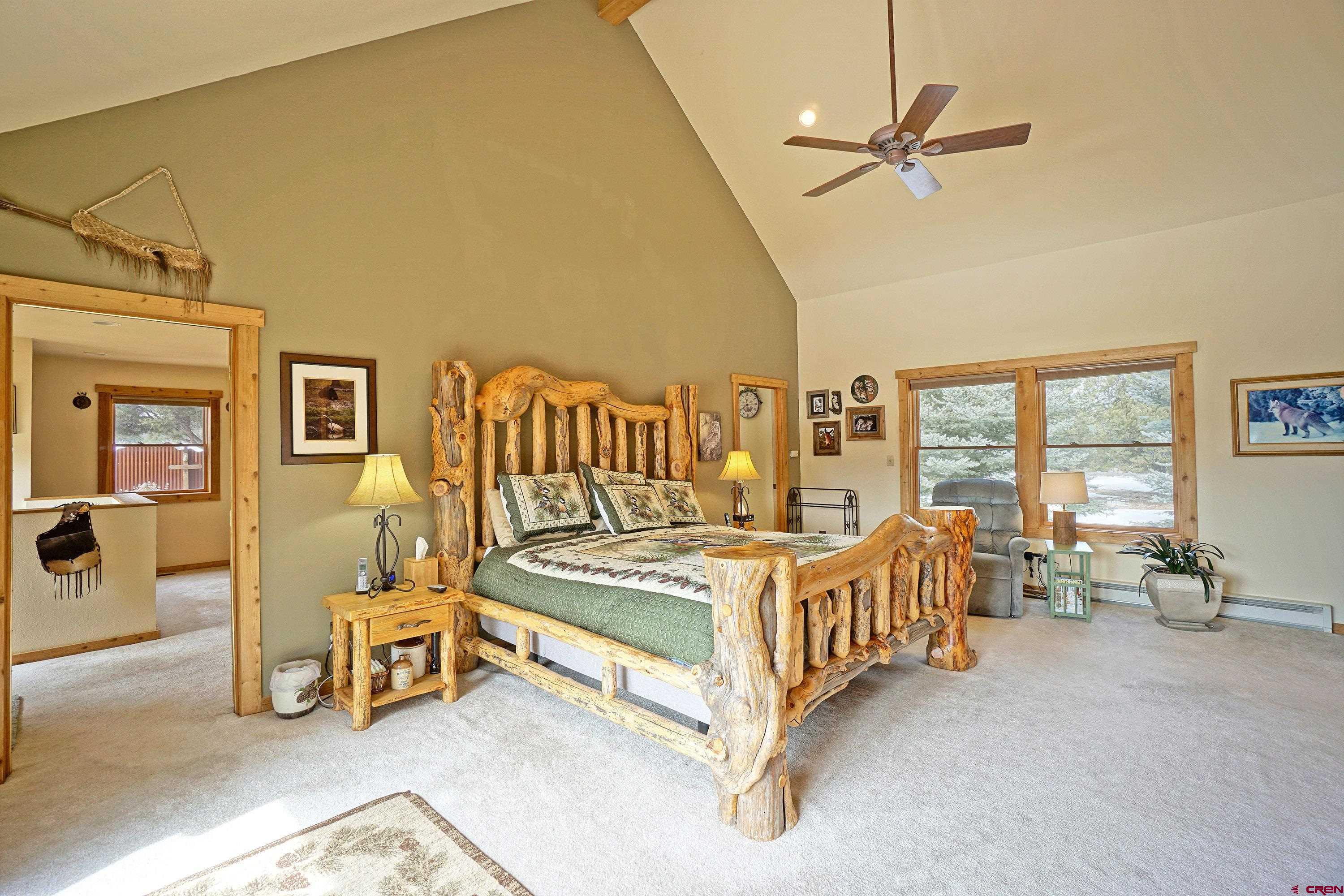 221 Waterview Lane Ridgway, CO 81432 - Photo 16 of 43 a bedroom with furniture and a large window