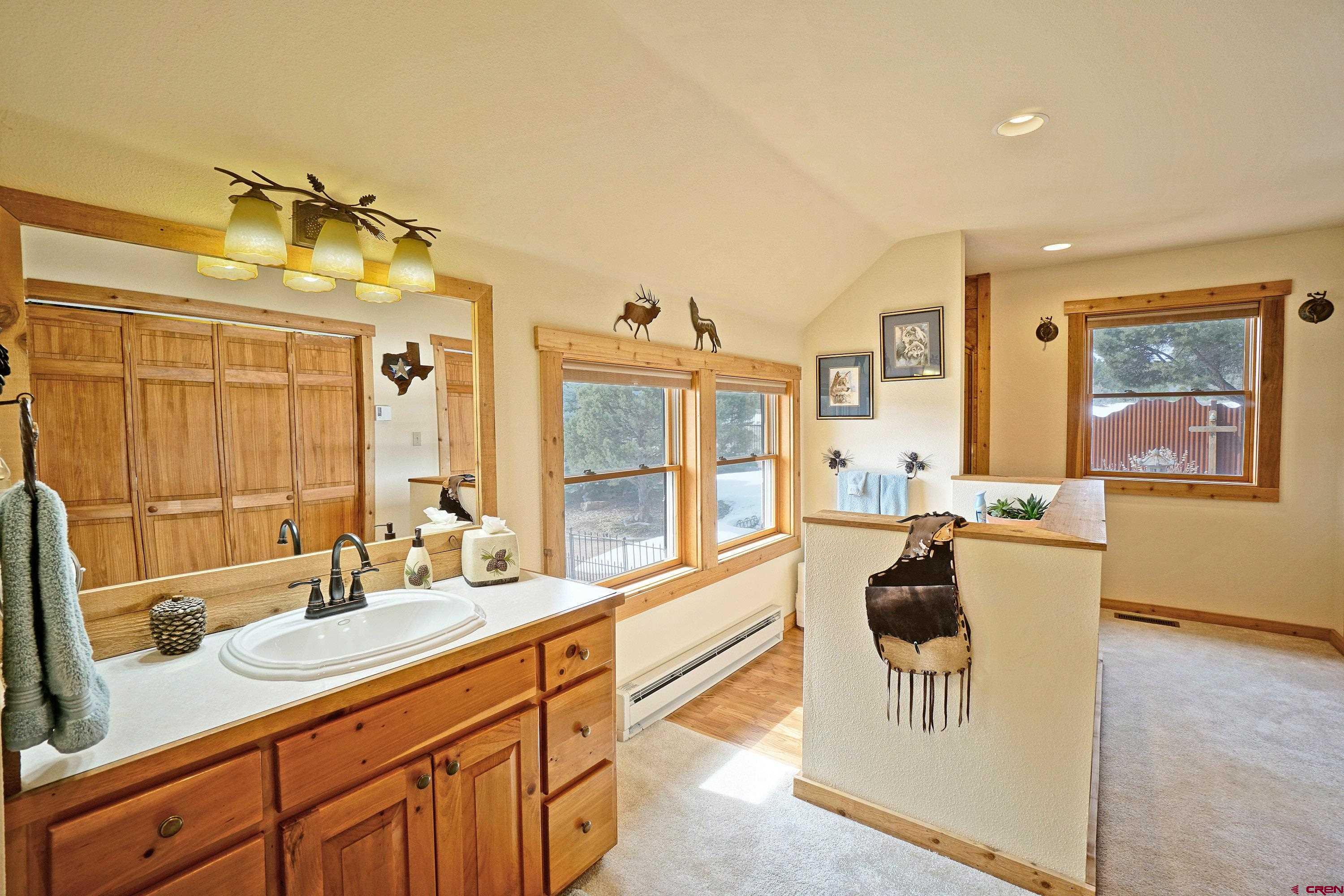 221 Waterview Lane Ridgway, CO 81432 - Photo 19 of 43 a spacious bathroom with a sink double vanity and a tub