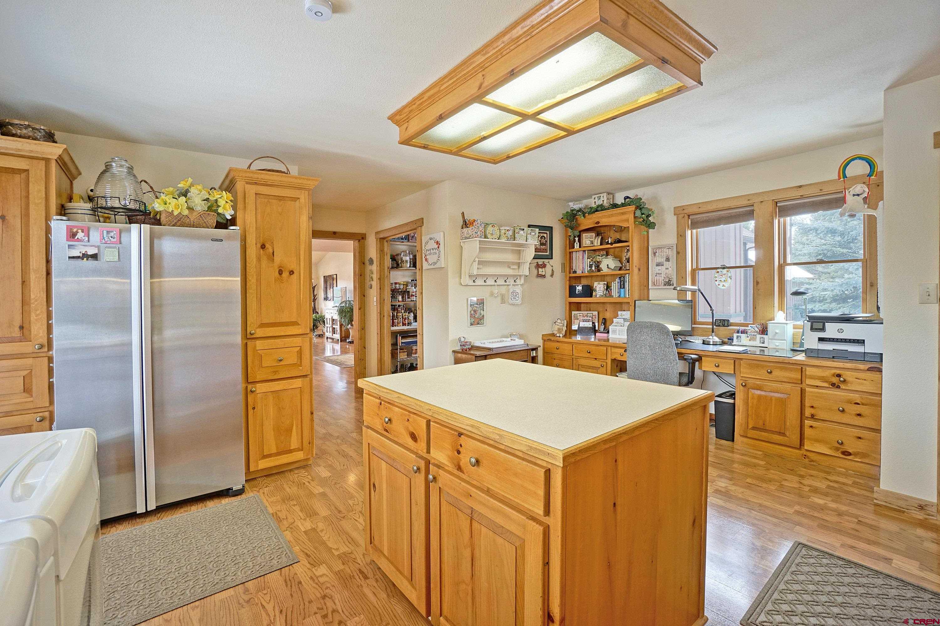 221 Waterview Lane Ridgway, CO 81432 - Photo 23 of 43 a kitchen that has a lot of cabinets in it and wooden floors