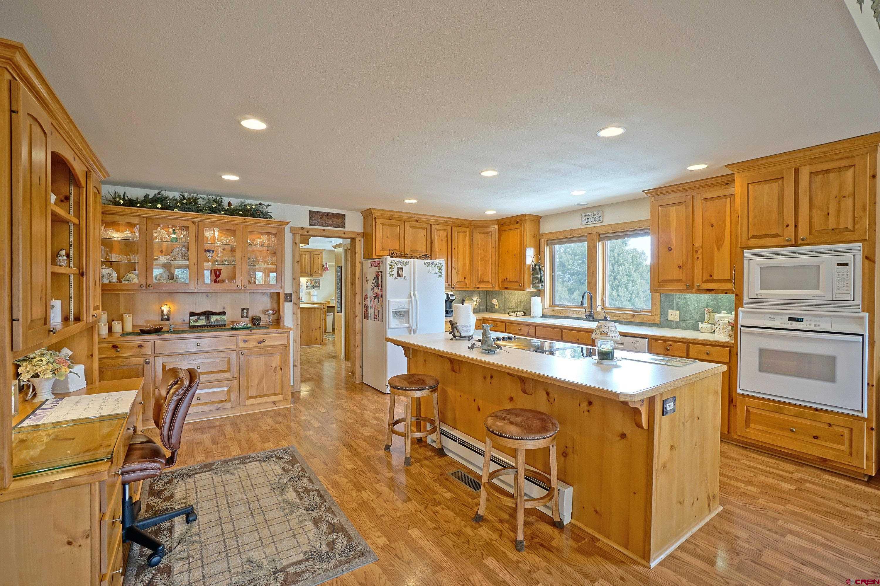 221 Waterview Lane Ridgway, CO 81432 - Photo 8 of 43 a large kitchen with kitchen island a large counter top space appliances and cabinets