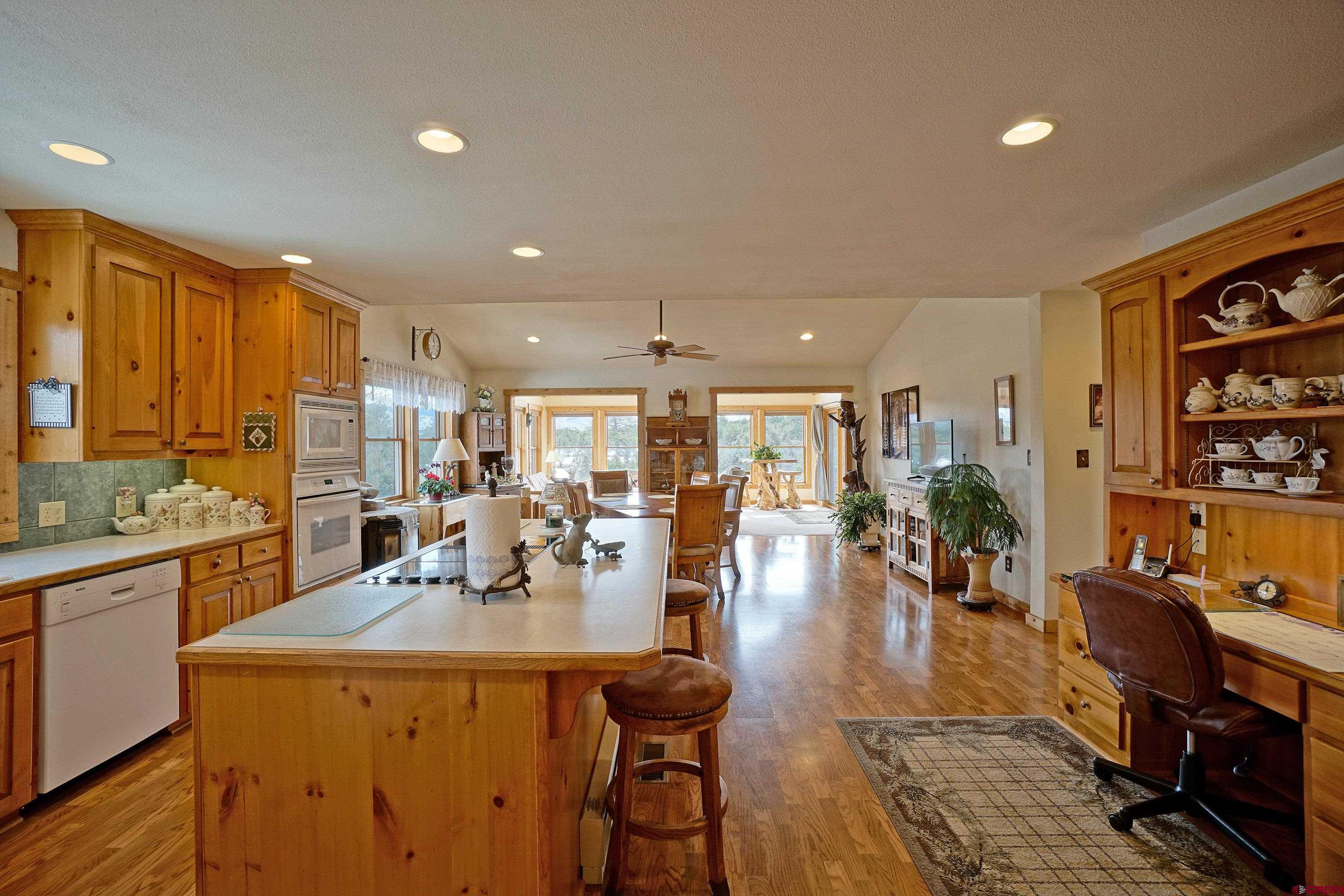 221 Waterview Lane Ridgway, CO 81432 - Photo 10 of 43 a view of a dining room with furniture window and wooden floor