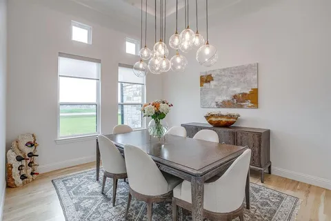 a view of a dining room with furniture and chandelier