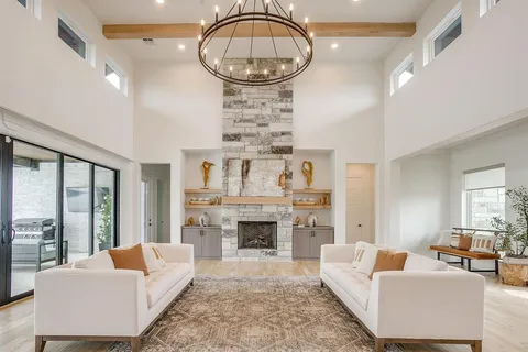 a living room with furniture a fireplace and a large window