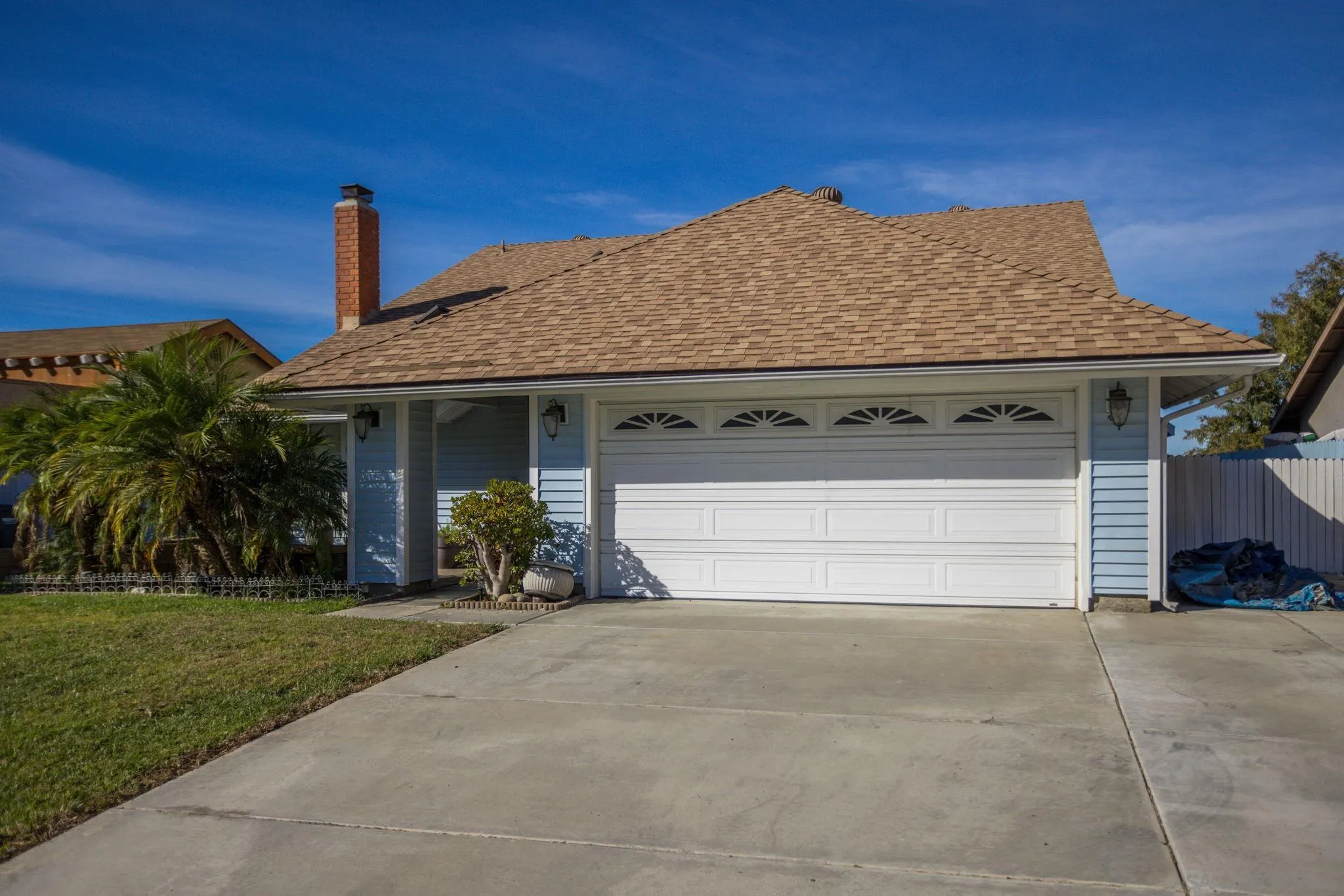 532 Kempton Street Spring Valley, CA 91977 - Photo 1 of 30 a front view of a house with a yard and garage