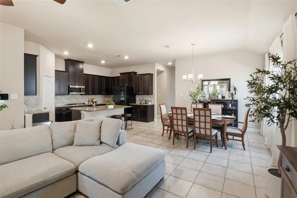 a living room kitchen with furniture and a dining table with kitchen view
