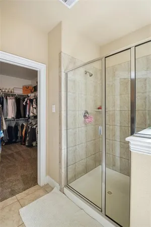 a bathroom with a glass shower door