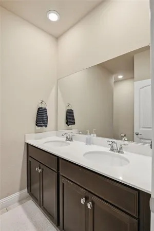 a bathroom with a double vanity sink and a mirror