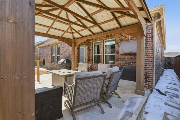 a view of a patio with table and chairs