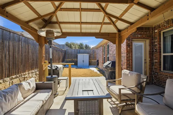 a view of a patio with a table and chairs