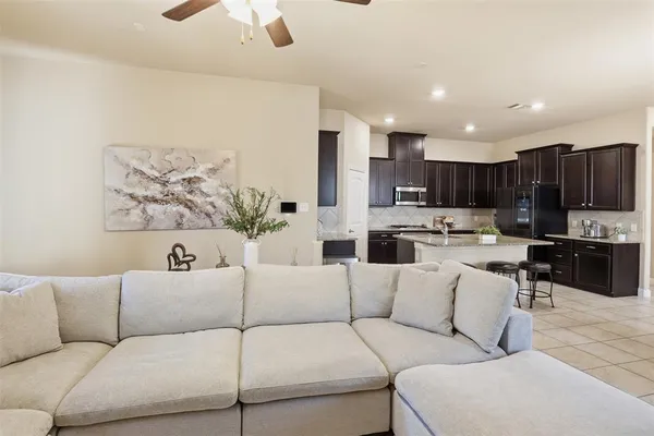 a living room with furniture and kitchen view